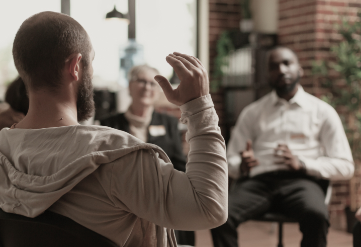 man-with-addiction-sharing-mental-health-issues-with-group-aa-meeting-talking-therapist-people-having-conversation-about-depression-rehabilitation-therapy-session 1